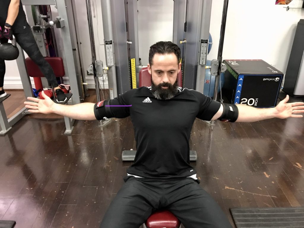 Moment arm in an adapted cable fly exercise