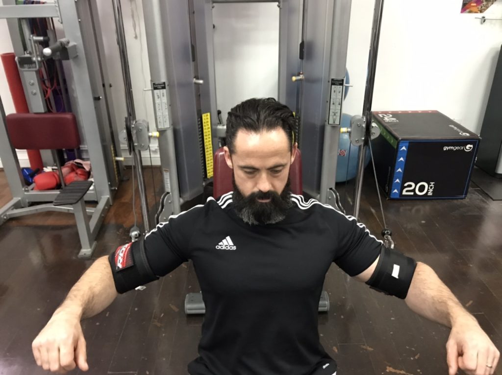 Adapted cable chest press for shoulder injury rehab start position